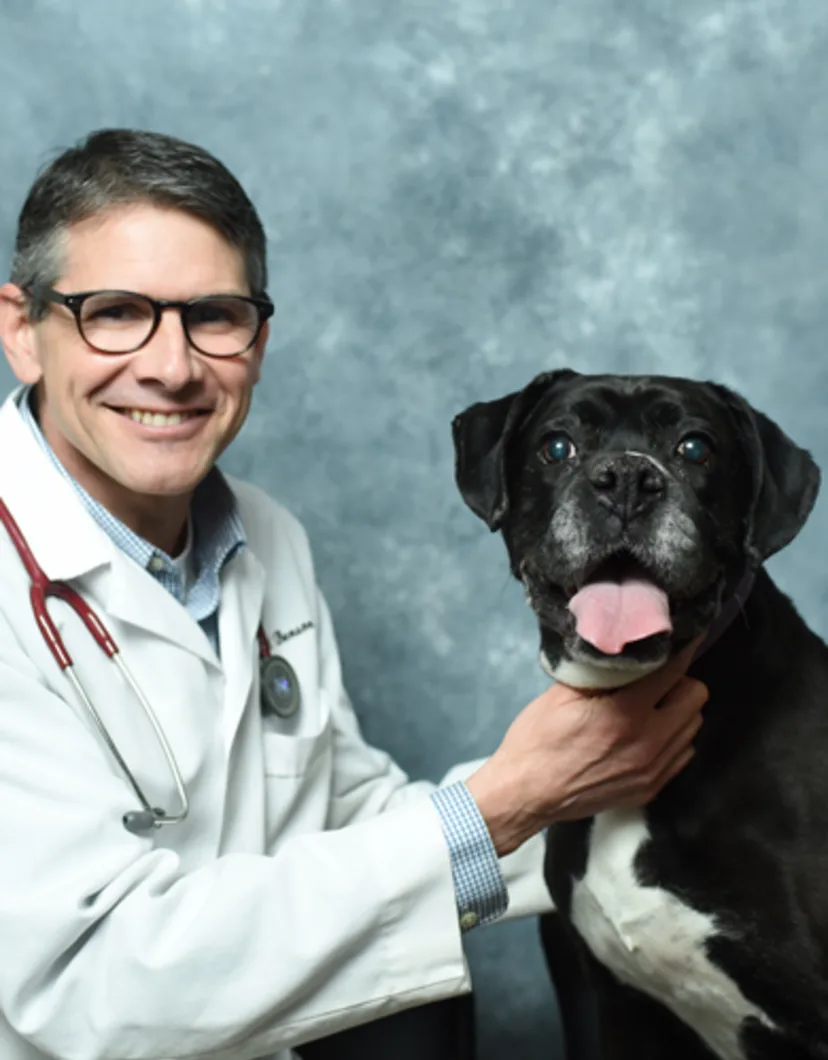 Dr. John A. Benson posing with a dog